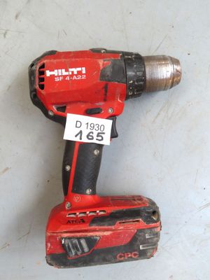 a red cordless drill with a price tag on it