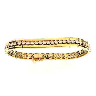 a close up of a gold and diamond bracelet on a white background