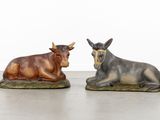 two figurines of a bull and a bull laying down
