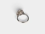 a close up of a silver ring on a white surface