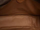 the inside of a brown purse with a zipper on it