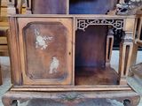 a wooden cabinet with a mirror on top of it