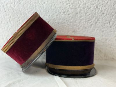 pair of red and blue striped hats on a white surface