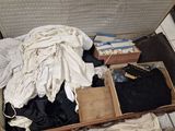 an open suitcase with clothes and other items in it