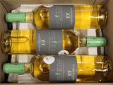 four bottles of white wine in a cardboard box on a table