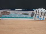 two packages of toothpaste sitting on top of a wooden table