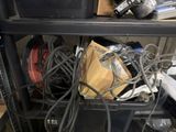 a black shelf with a bunch of wires on it
