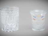 two glass vases sitting next to each other on a table