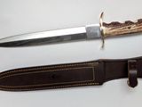a knife that is laying on top of a leather sheath