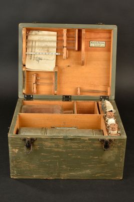 a small wooden box with music in it on a black background