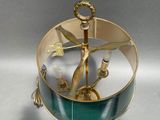 a gold and green glass box with a bird on it