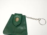 green leather coin purse with a keychain on a white background