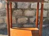 a small wooden table with a shelf on top of it