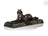 statue of a cat laying on a marble base with a white background