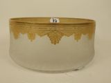a glass bowl with a gold decoration on it