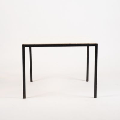 rectangular dining table with black legs and a white marble top