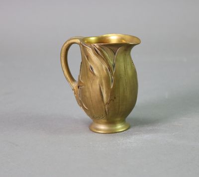 a gold vase that is sitting on a table