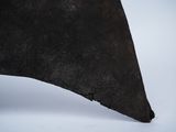 a close up of a piece of metal on a white surface