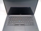 a laptop with a keyboard on it sitting on a table