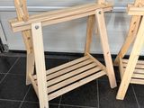 two wooden chairs sitting next to each other on a tiled floor