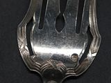 a fork that is sitting on top of a black table