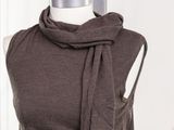 the top of a mannequin with a scarf around it ' s neck