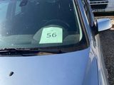 a car with a price tag on it parked in a parking lot