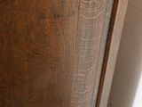 a wooden cabinet with a drawer on top of it