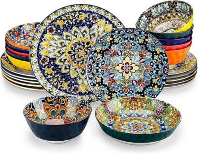 multicolored plates and bowls are stacked on top of each other