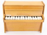 an image of a wooden piano sitting on top of a white surface