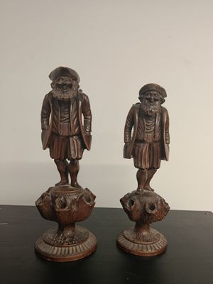 two figurines of two men standing on top of a table