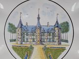 a decorative plate with a picture of a castle on it