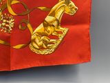 a red and gold scarf with a horse on it