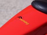 a close up of a red motorcycle with a black seat