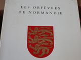 the book is sitting on top of a table with a red and white cover