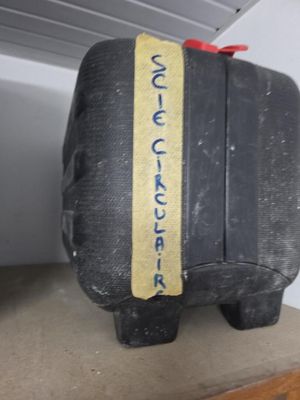 a black suitcase with a yellow stripe on it sitting on a shelf