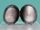 a close up of two silver lockes on a table