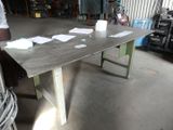 a man that is standing next to a table with papers on it