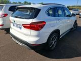 a white bmw suv parked in a lot next to other cars