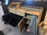 a desk with drawers and bins in a room