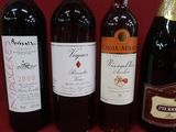 several bottles of wine are lined up on a red surface