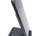a cell phone that is sitting on top of a stand