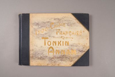 un vieux livre posé sur une table à côté d'un mur blanc