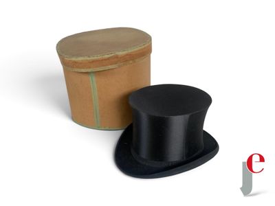 a black top hat sitting next to a cardboard box