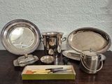 a table with silverware on it and a knife on the table