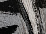 a close up of a piece of wood with black paint on it