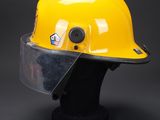 a close up of a yellow hard hat with a clear vise
