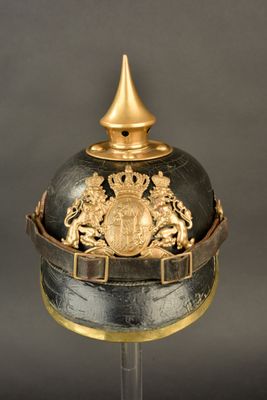 an old helmet with a golden crown on top of it
