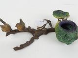 figurine of a bird perched on a branch with a bird on it ' s head