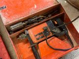 a red box with a hammer and other tools in it